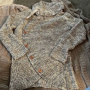 Black and gray sweater. 100% acrylic. Size 2X. Has asymmetrical button detail.